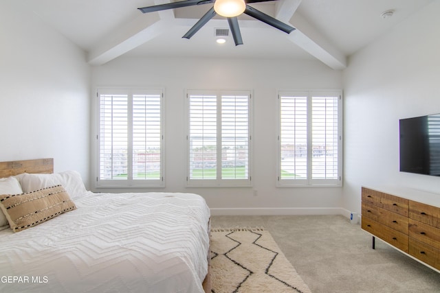 bedroom featuring ceiling fan, lofted ceiling with beams, light carpet, and multiple windows