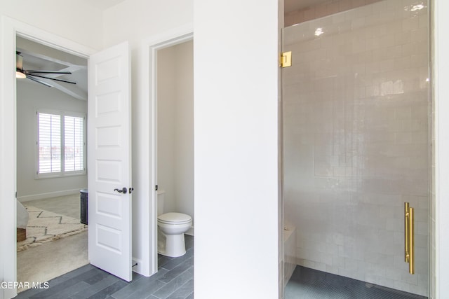 bathroom featuring lofted ceiling, ceiling fan, an enclosed shower, and toilet