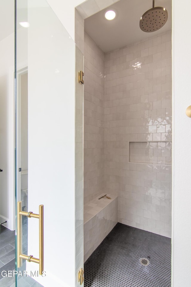 bathroom with tiled shower