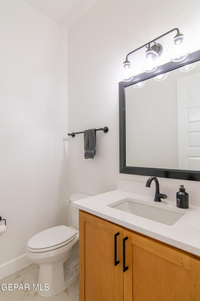 bathroom featuring tile patterned floors, vanity, and toilet