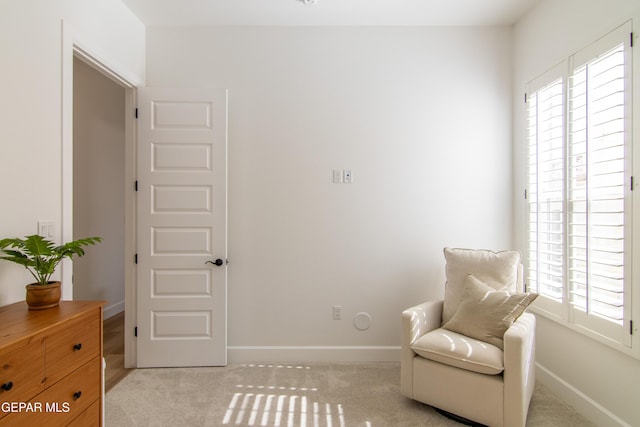 living area featuring light carpet