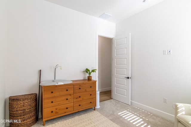 bedroom featuring light carpet