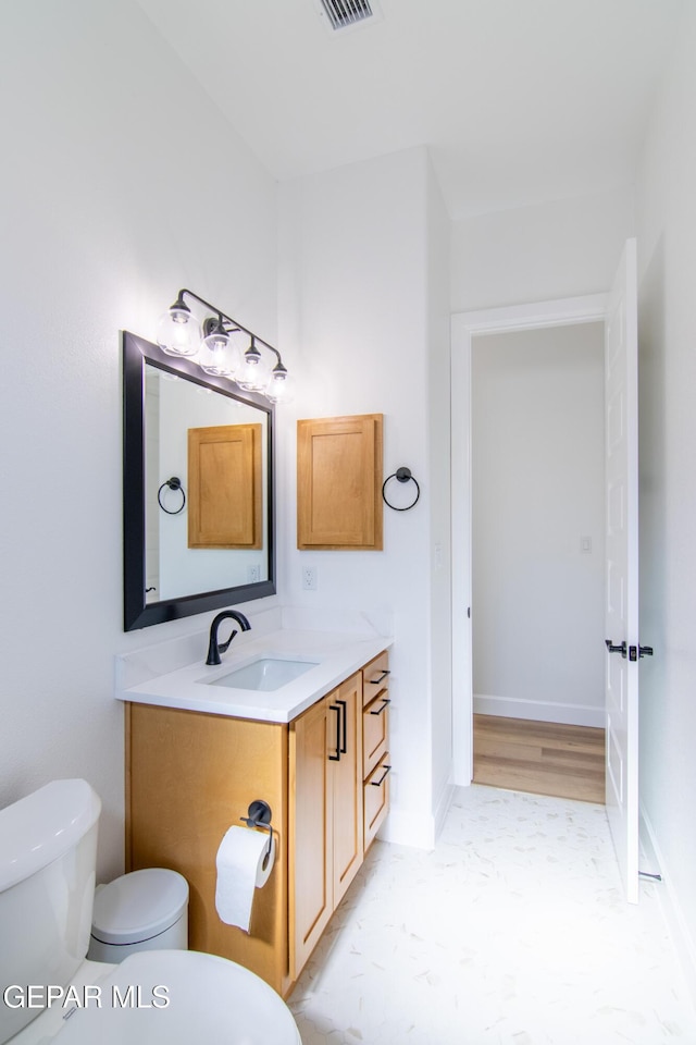 bathroom featuring vanity and toilet