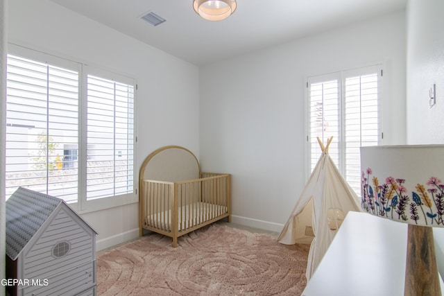 carpeted bedroom with a crib