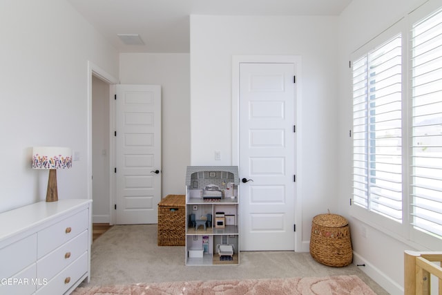 bedroom featuring light colored carpet