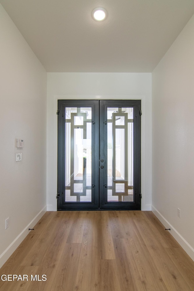 interior space featuring french doors and light wood-type flooring