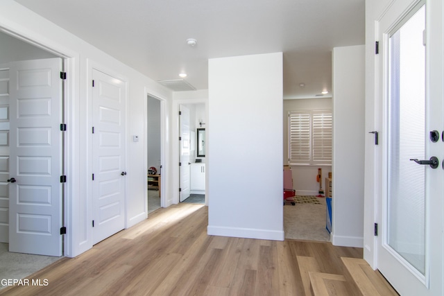 corridor with light hardwood / wood-style flooring