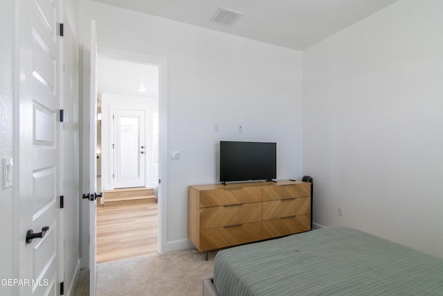 bedroom with light carpet