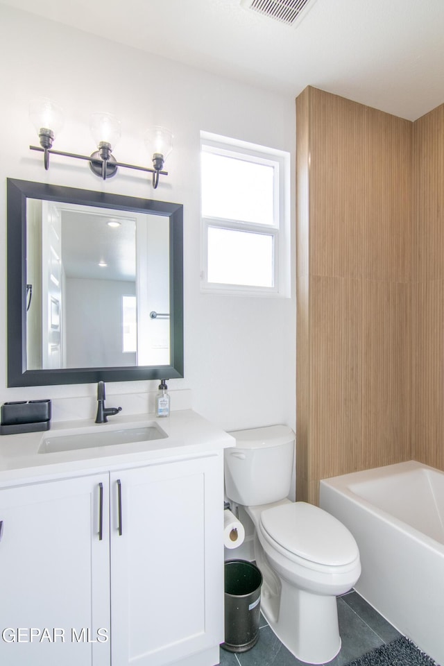 full bathroom with tile patterned floors, shower / washtub combination, vanity, and toilet