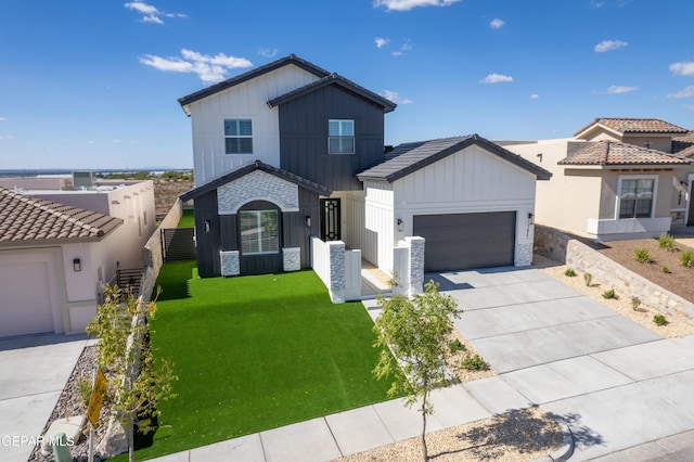 view of front of home with a front lawn and a garage