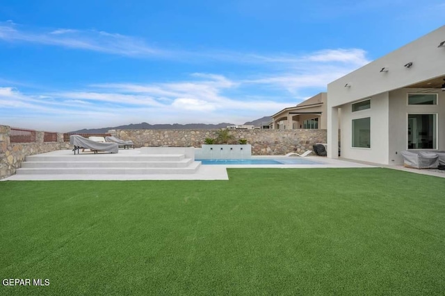 view of yard with a fenced in pool