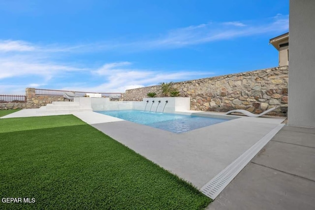 view of pool featuring a patio area and a yard