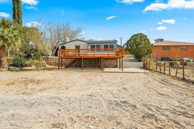 back of house with a deck