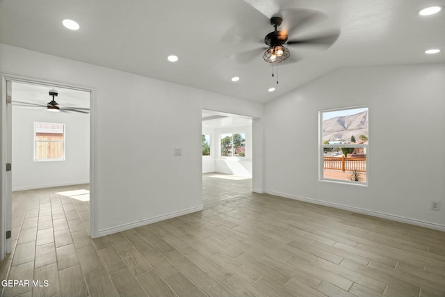 spare room featuring ceiling fan, plenty of natural light, and vaulted ceiling