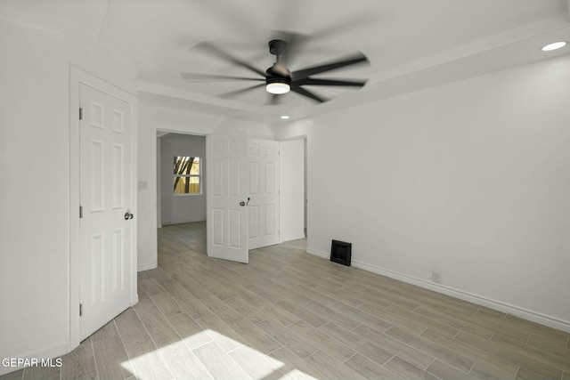 empty room featuring ceiling fan and light hardwood / wood-style floors