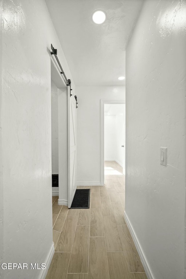 hall featuring a barn door