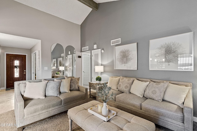 living room featuring beamed ceiling and high vaulted ceiling