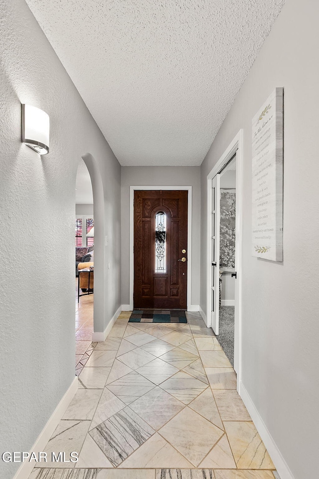 foyer featuring a textured ceiling