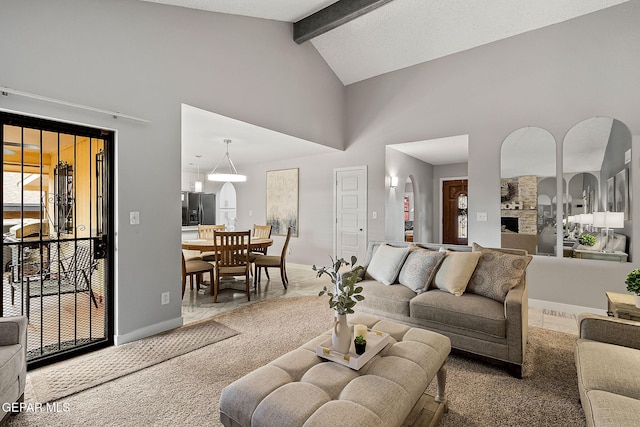 living room featuring beam ceiling, carpet, and high vaulted ceiling