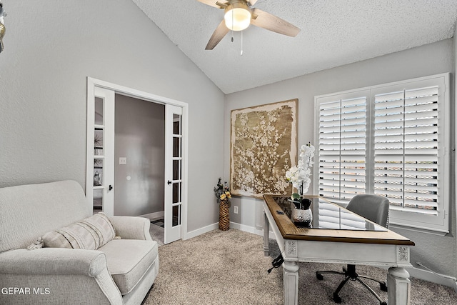 carpeted office with a textured ceiling, a wealth of natural light, ceiling fan, and lofted ceiling