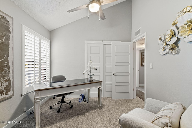 carpeted office with ceiling fan, lofted ceiling, and a textured ceiling