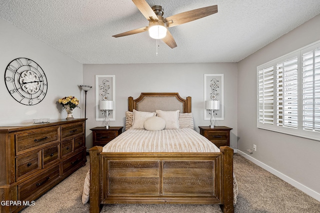 carpeted bedroom featuring ceiling fan and a textured ceiling