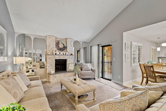 living room with a fireplace, carpet floors, a textured ceiling, and high vaulted ceiling