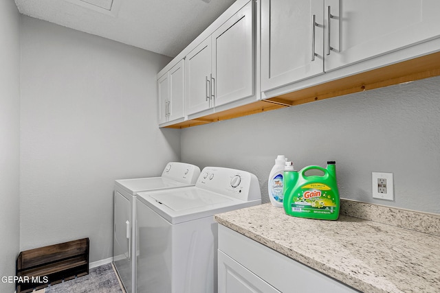 washroom with cabinets, hardwood / wood-style flooring, and washer and clothes dryer