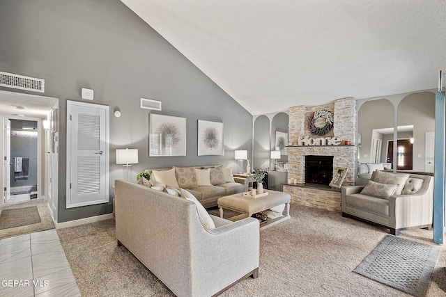 tiled living room featuring a fireplace and high vaulted ceiling