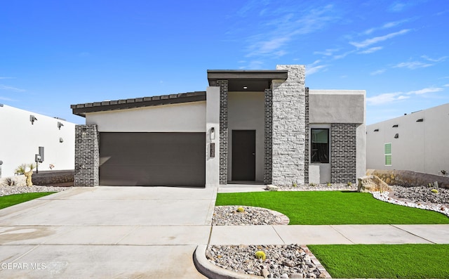 view of front of property with a garage and a front yard