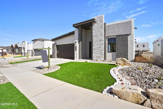 view of front of property featuring a garage and a front lawn