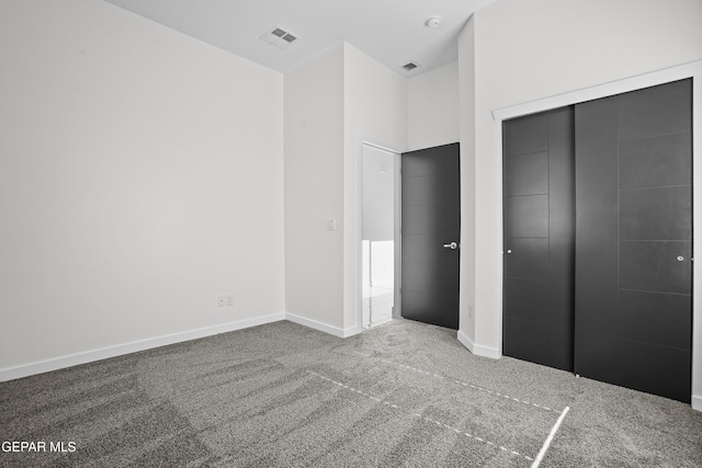 unfurnished bedroom featuring carpet and a closet