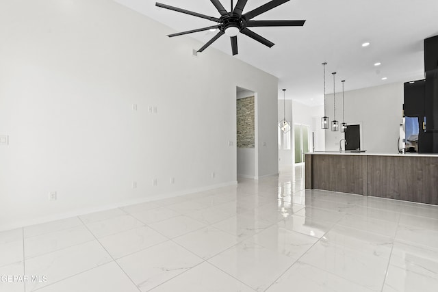 unfurnished living room with ceiling fan