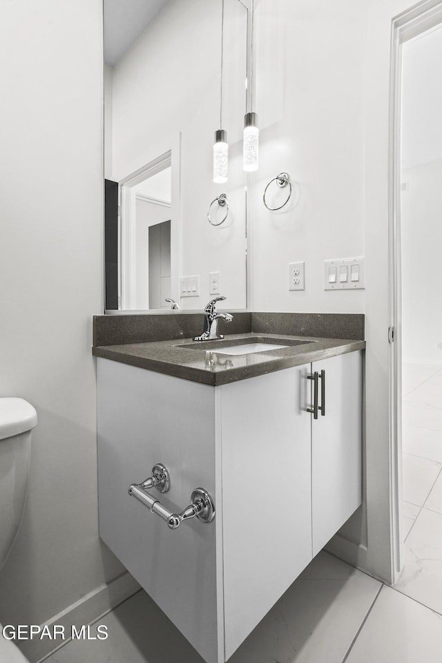 bathroom featuring vanity, toilet, and tile patterned flooring