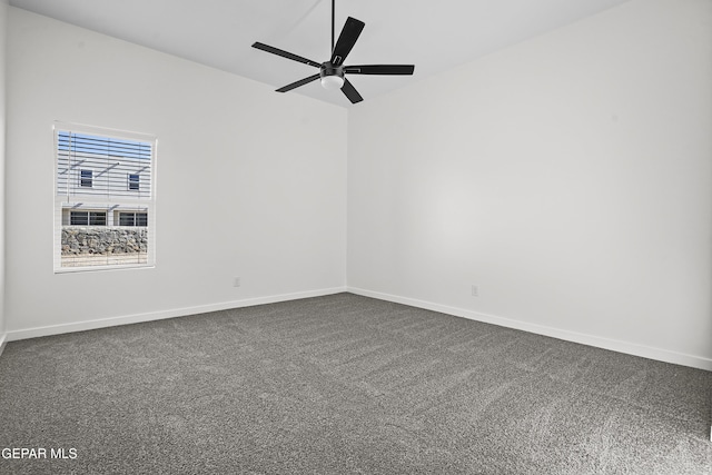 empty room with dark colored carpet and ceiling fan