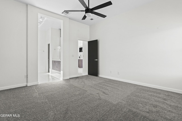 unfurnished bedroom with carpet floors, ceiling fan, and a high ceiling