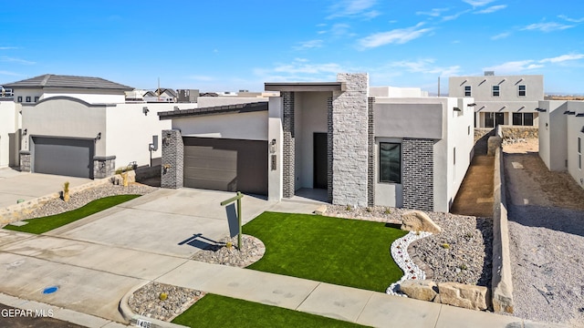 view of front of house with a garage and a front yard