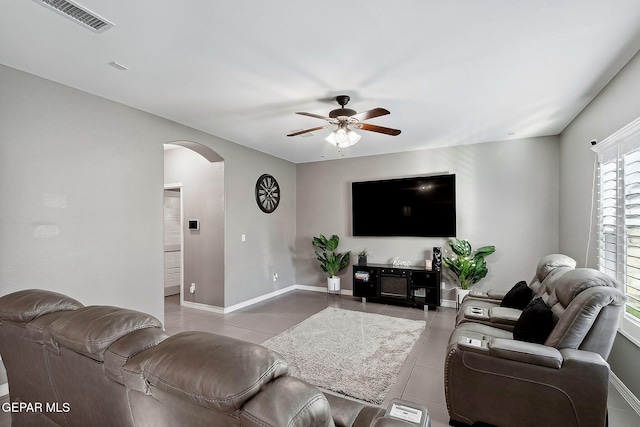 tiled living room with ceiling fan