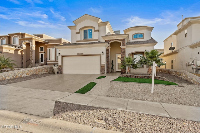 7828 Enchanted View Dr, El Paso, TX 79911 - mediterranean / spanish-style home featuring stucco siding, stone siding, concrete driveway, and an attached garage