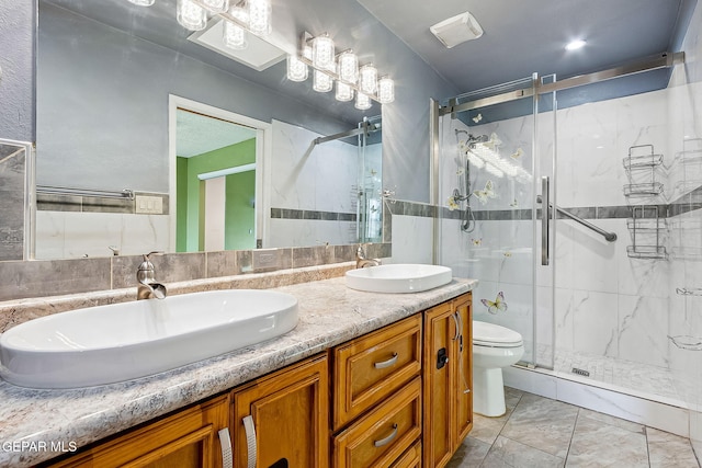 bathroom with vanity, an enclosed shower, and toilet