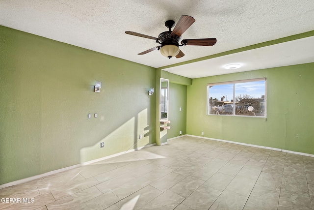 unfurnished room with ceiling fan and a textured ceiling