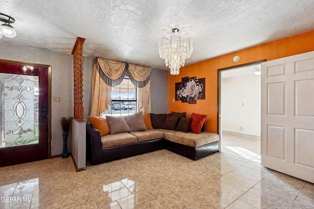 living room with a textured ceiling, an inviting chandelier, and light tile patterned flooring