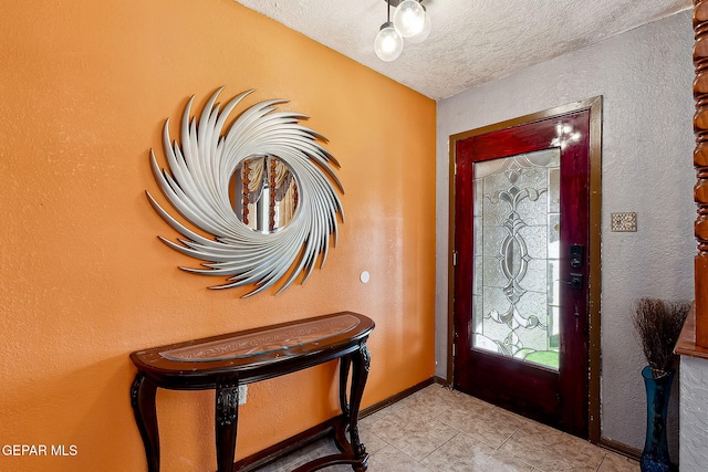 tiled foyer entrance featuring a textured ceiling