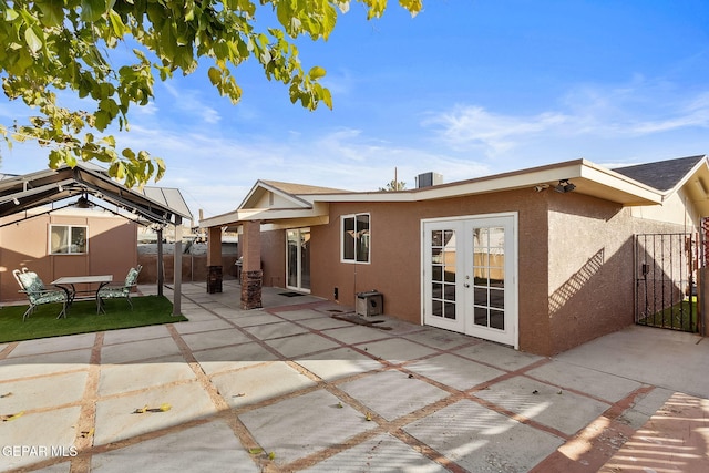 rear view of property with french doors and a patio