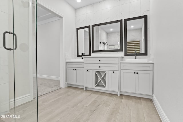 bathroom with vanity and a shower with shower door