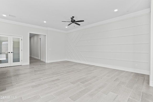 empty room with ceiling fan, light wood-type flooring, crown molding, and french doors