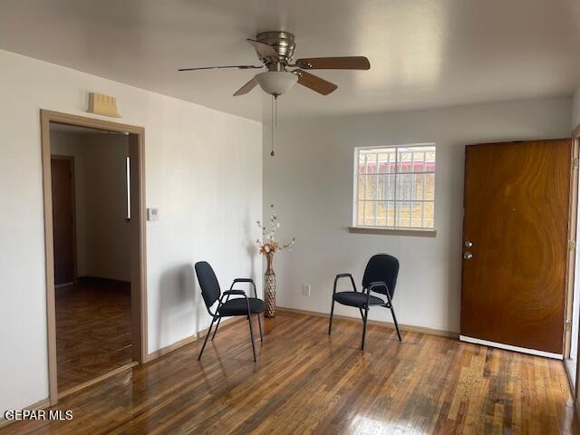 sitting room with ceiling fan and dark hardwood / wood-style flooring