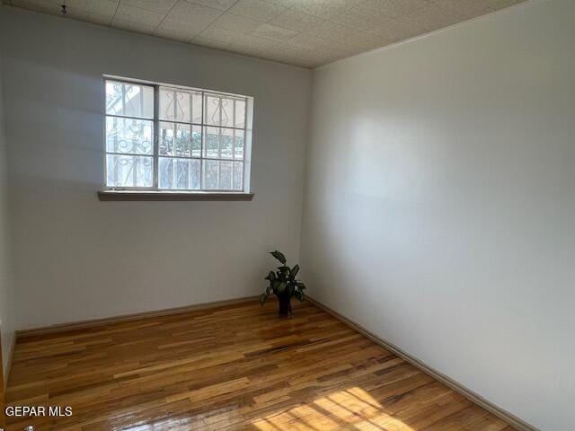 empty room with hardwood / wood-style floors