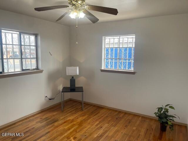 empty room featuring hardwood / wood-style floors and ceiling fan