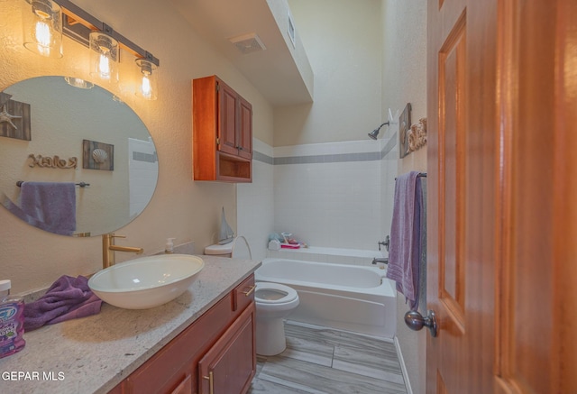 bathroom with visible vents, shower / tub combination, vanity, and toilet